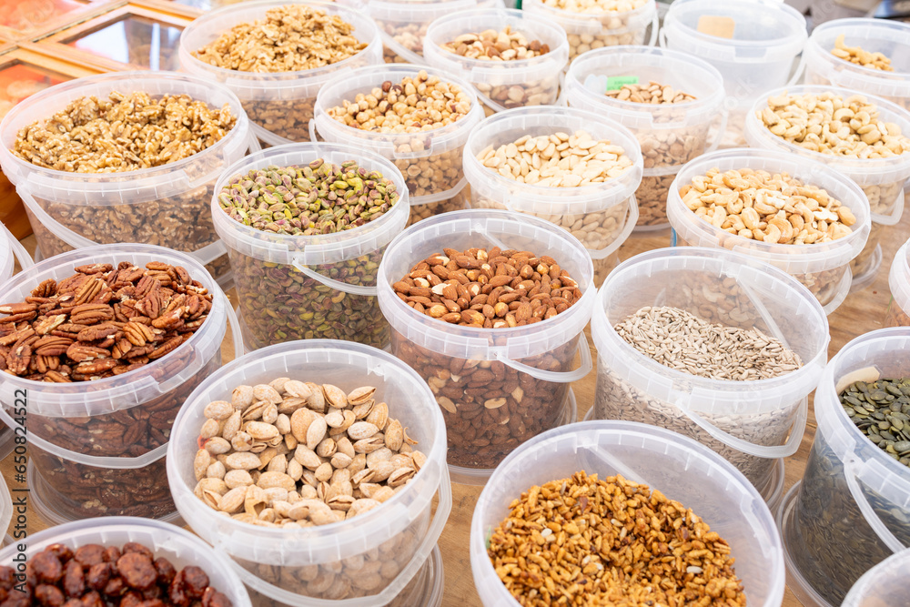 Delightful assortment of fresh, roasted, and candied nuts at the vibrant local market.