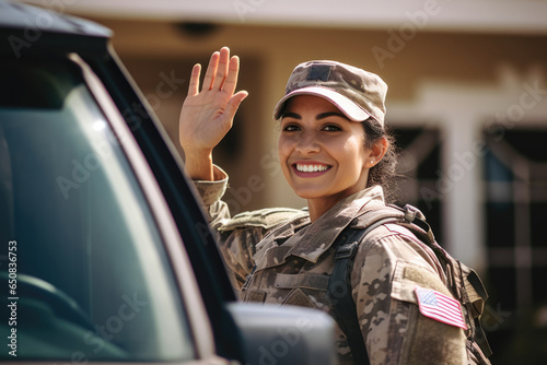 Happy servicewoman waving her hand on her homecoming photo