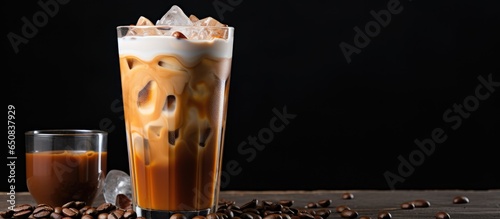 Fotografia Cold brew coffee with milk poured over it in a glass