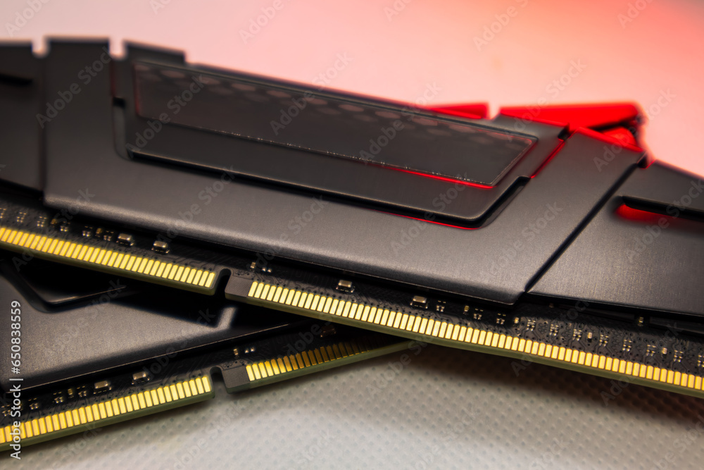 DDR4 DRAM memory modules in red light. Computer RAM chip close-up on white. Desktop PC memory parts DDR4 DRAM memory modules in red light. Computer RAM chip close-up on white. Desktop PC memory parts