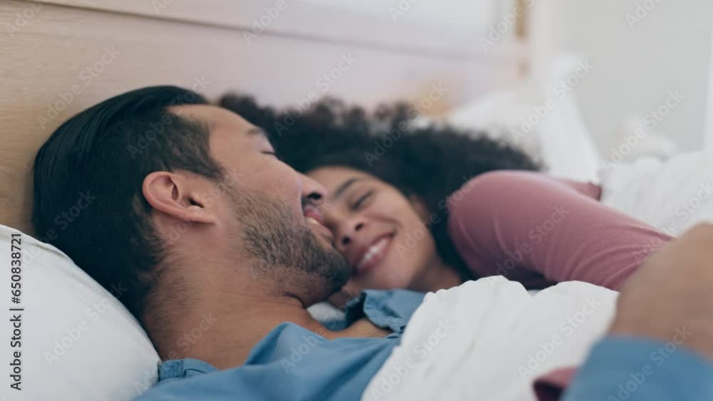 Love, relax and wake up in bed with a couple together in their home on a weekend morning for romance. Bedroom, smile or happy with a man and woman in their apartment for bonding or affection
