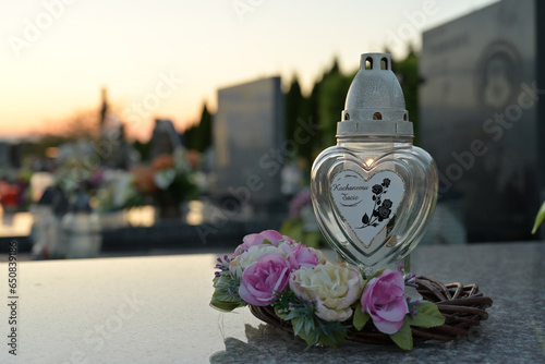 Candle and flowers on the grave photo