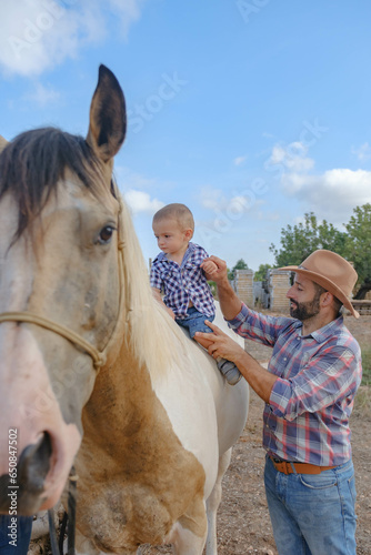 father teaching his son the hobby of horses