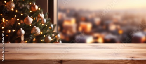 Backdrop for showcasing or arranging items featuring wooden surface cutting surface and hazy kitchen with a holiday tree