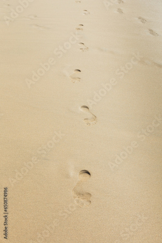 Human footprint on sand summer tropical beach background
