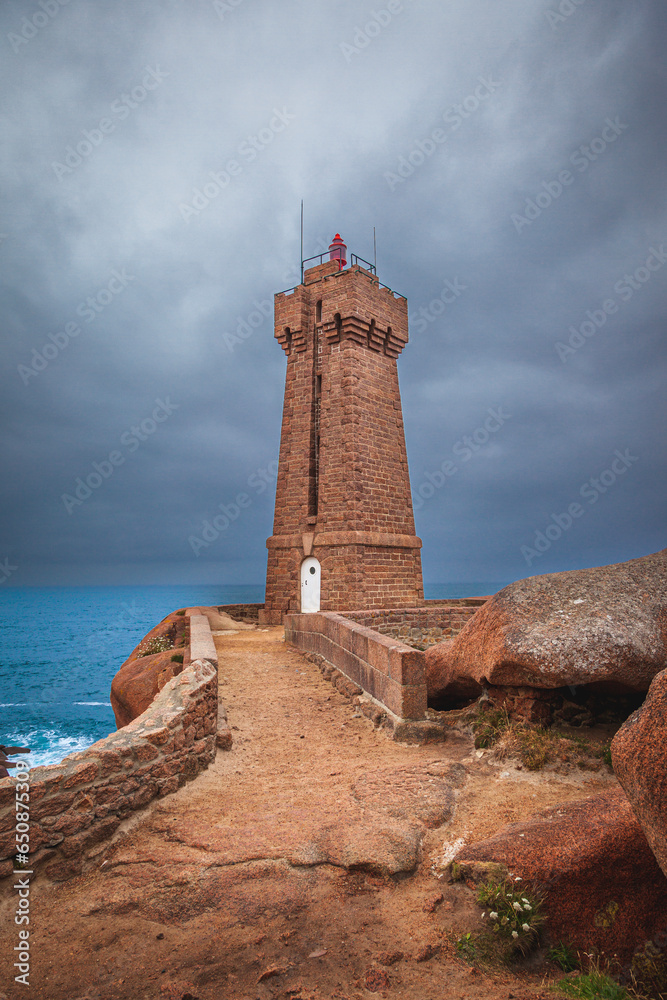 panoramic view of the famous Ploumanach lighthouse among the giant pink boulders in Brittany