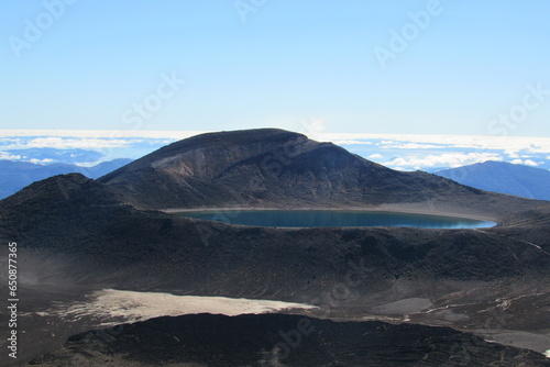 Scenic view of a lake surrounded by rocky hills in Tongariro National Park, New Zealand