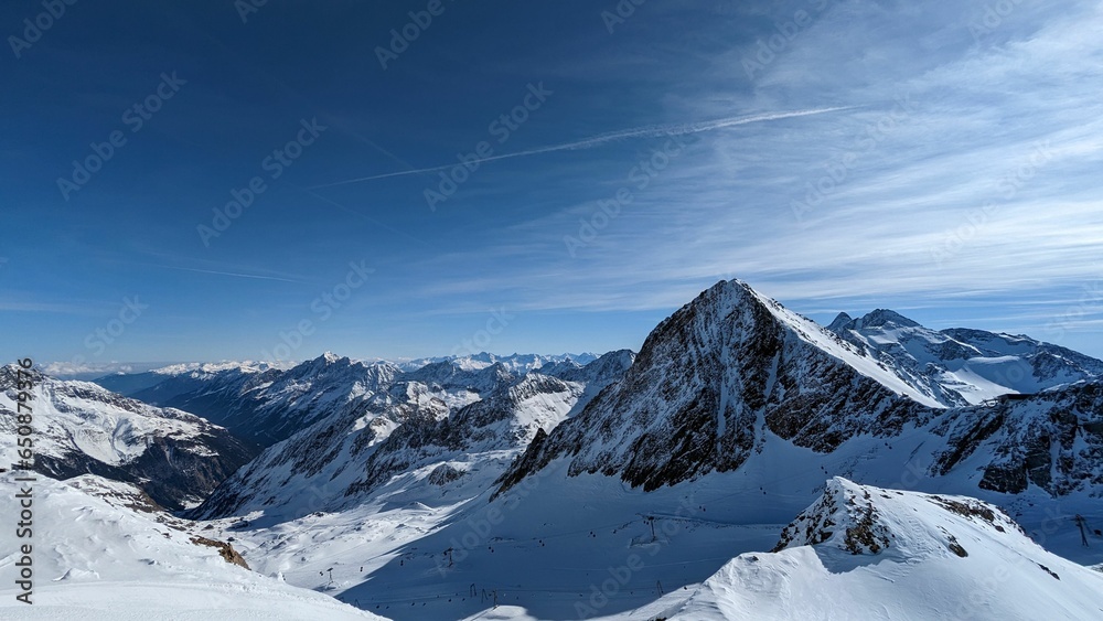 a mountain view with many slopes and small snow - covered hills in the foreground