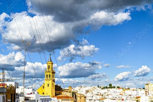Church of Santiago de Alcala de Guadaira, Seville, Spain under a cloudy blue sky photo
