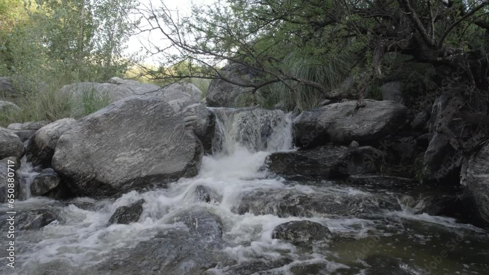 Close-up view of a streaming river on rocks in a forest Close-up view of a streaming river on rocks in a forest