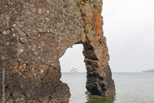 Glimpse of a Cruise Ship on a Foggy, Smoky Day on Lake Superior Through the Arch of the Sea Lion Arched Rock Formation