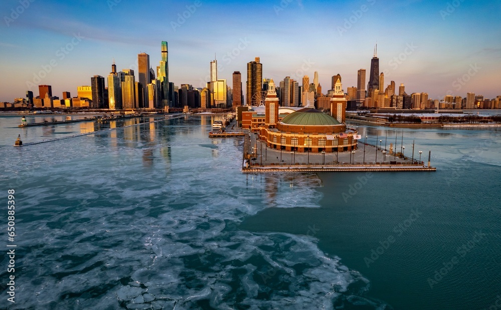 Aerial Chicago skyline at sunrise with a view of the navy pier and frozen lake Michigan