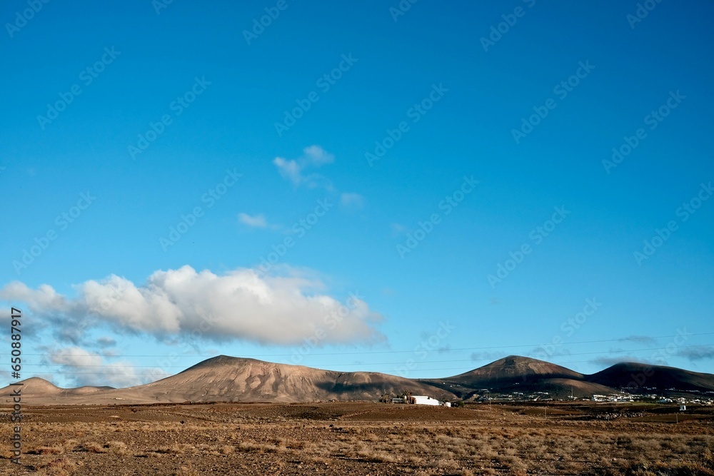 an empty field with dirt and mountains in the distance, in the far distance, an empty field with dirt and mountains in the distance, in the far distance,