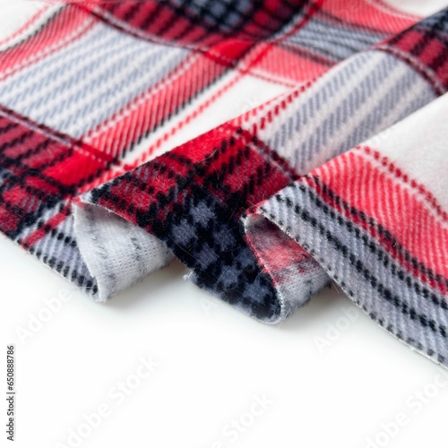Close up shot of plaid red and white fabric on a white background