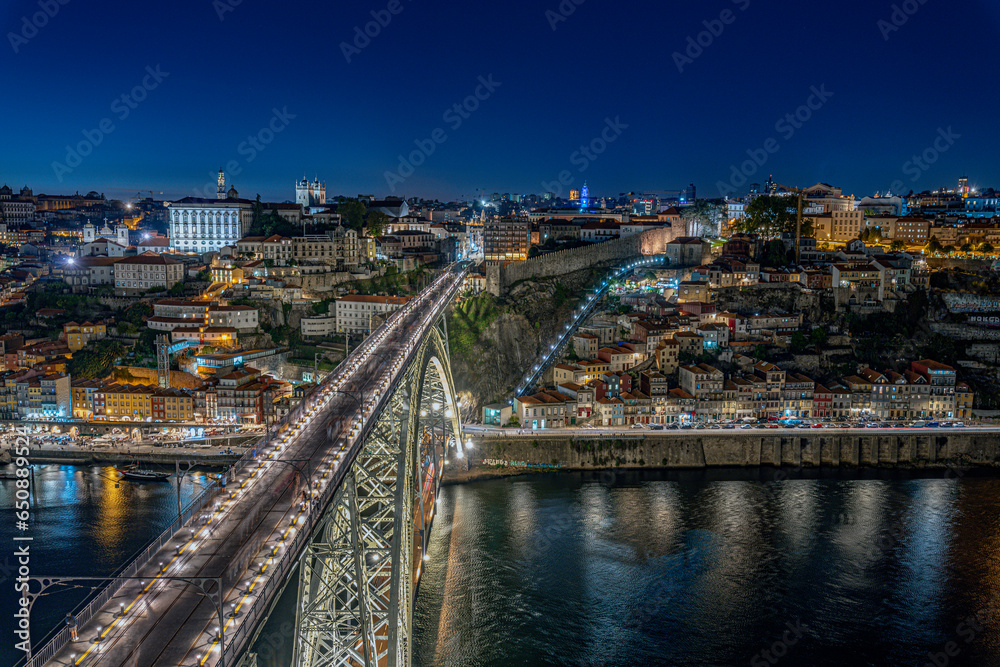 Fototapeta premium Panoramic view of cityscape of Porto, Portugal over Dom Luis I Bridge and Douro River at sunset