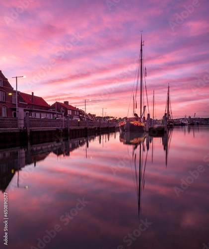 Beautiful view of purple sunset over the river with sailboats
