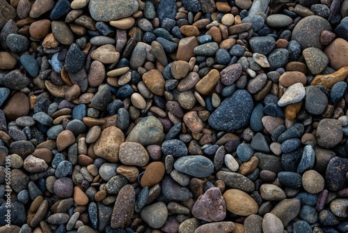 Stunning beach view of shoreline, with a mix of various toned rocks and gravel
