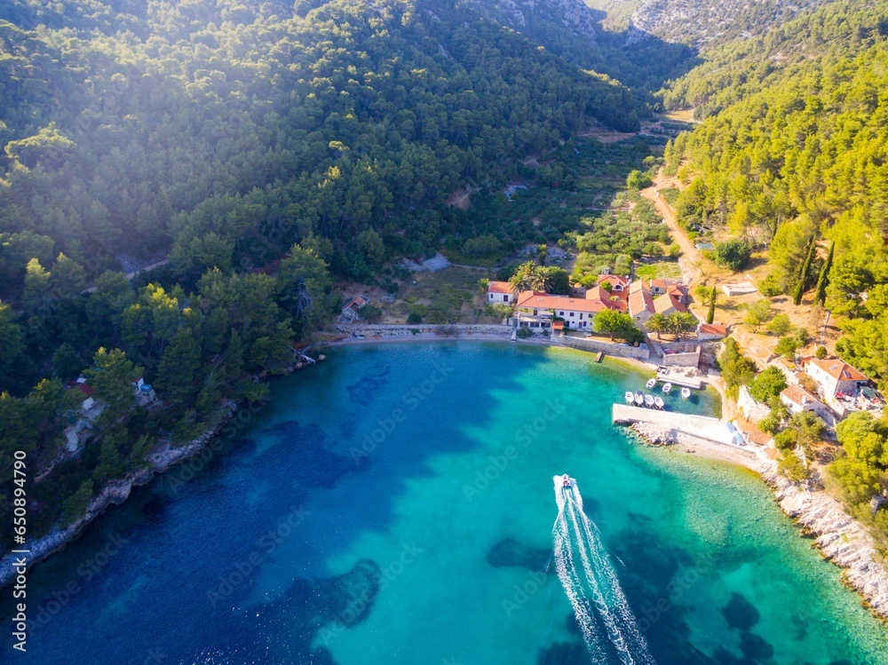 Aerial view of the scenic Island Hvar Bay Smarska on a sunny day with a sailing boat
