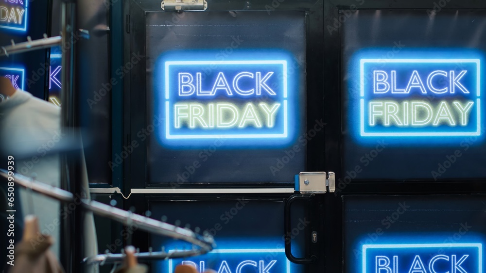 Fototapeta premium Front door of clothing shop open on black friday promotions day, special offers for merchandise and discounted items. Signs and banners showing big sales in retail store boutique.