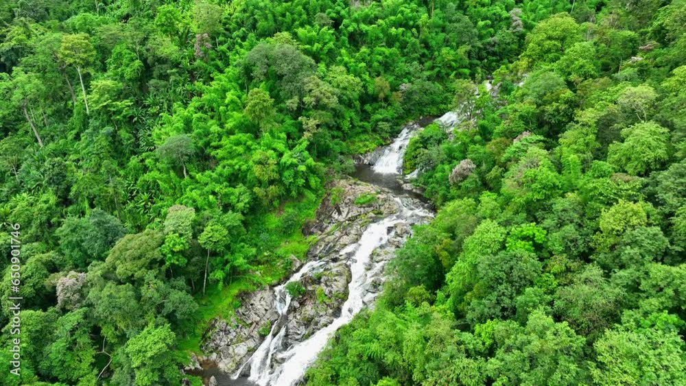 A symphony of water in motion. Crystal-clear water tumbles down from a precipice, sparkling like liquid diamonds as it splashes over rugged rocks and boulders. Khlong Nam Lai Waterfall. Drone.
A symphony of water in motion. Crystal-clear water tumbles down from a precipice, sparkling like liquid diamonds as it splashes over rugged rocks and boulders. Khlong Nam Lai Waterfall. Drone.