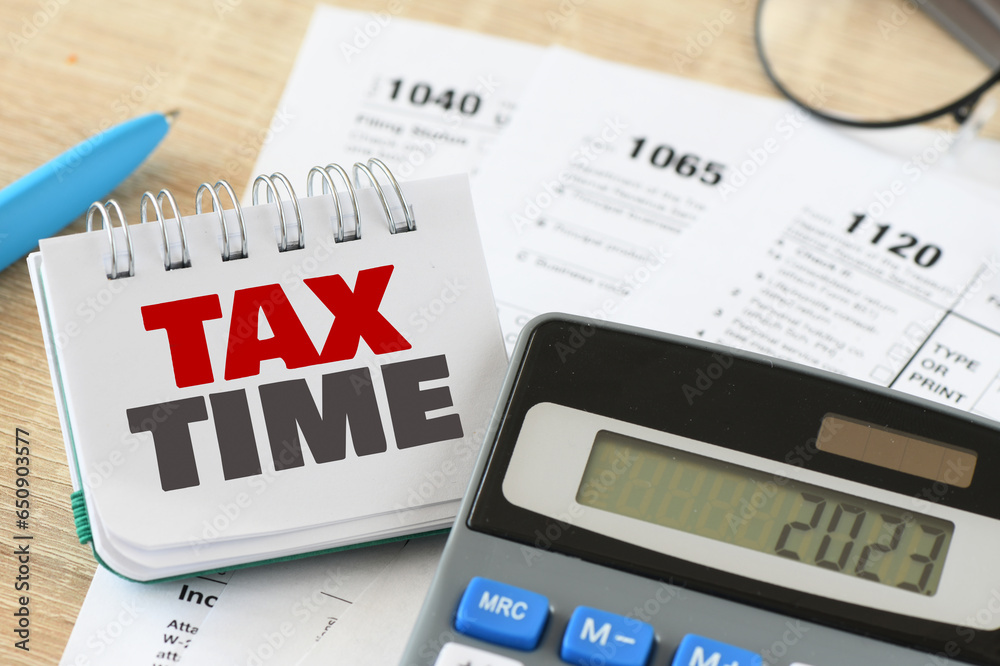 Naklejka premium Tax time words in office notebook. Business concept.