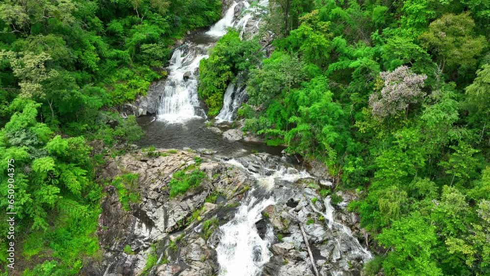 The waterfall in tropical rainforest, surrounded by lush greenery and vibrant flora. Towering trees and diverse plant species create a soothing atmosphere. (Khlong Nam Lai Waterfall, Thailand).
The waterfall in tropical rainforest, surrounded by lush greenery and vibrant flora. Towering trees and diverse plant species create a soothing atmosphere. (Khlong Nam Lai Waterfall, Thailand).