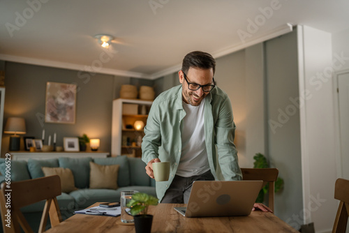 one man adult caucasian work on laptop at home happy smile