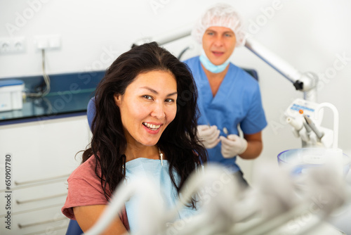 Portrait of happy asian woman after dental treatment in dental clinic