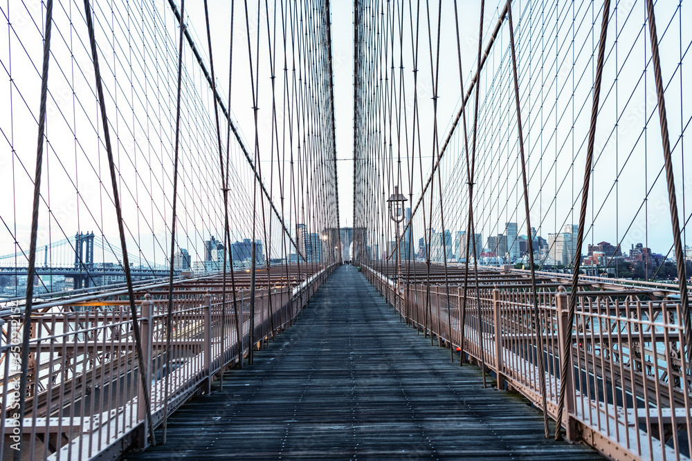 Naklejka premium brooklyn bridge to manhattan. urban architecture landmark of brooklyn bridge. architecture of metropolis city. brooklyn bridge. new york city architecture. urban architecture defines the skyline