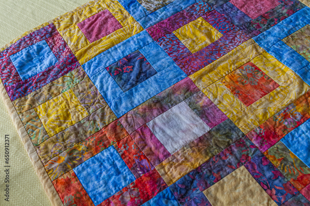 Hand-quilted batik fabric table runner quilt. Hand-quilted batik fabric table runner quilt.