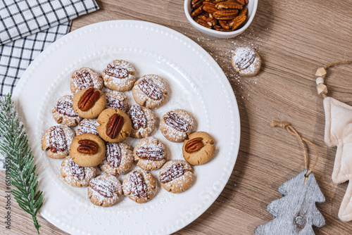 Christmas cookies with nuts on a plate on a wooden table