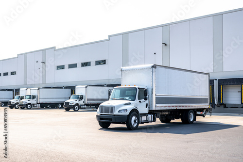 Canvas Print Huge warehouse building with docks and gates and loading cargo middle duty day c