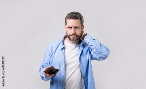 concerned moneyless man with wallet in studio. moneyless man with wallet at hand.
