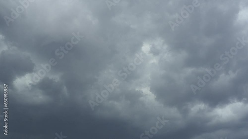 Sky and gray clouds. Puffy fluffy dark clouds. Cumulus cloud cloudscape time lapse. Autumn or winter sky time lapse. Nature weather forecast. Rainy clouds background. Cloud dramatic rapid video storm. photo