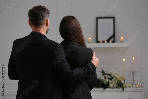 Foto Couple mourning indoors, back view and space for text