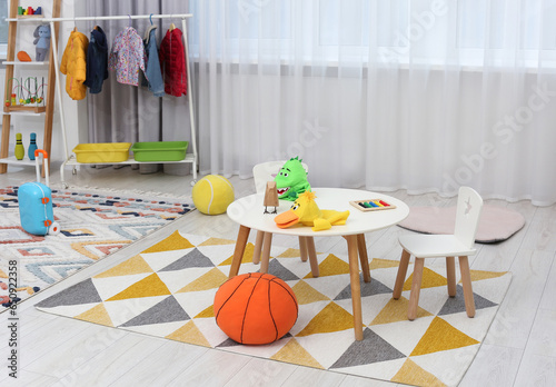 Child`s playroom with different toys and modern furniture. Stylish kindergarten interior