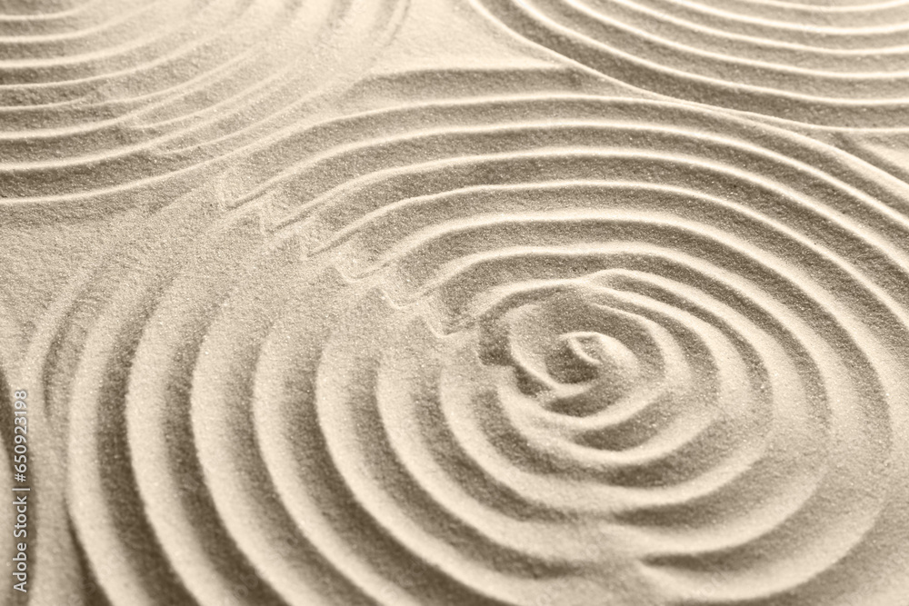 Naklejka premium Beautiful patterns on sand, closeup. Zen garden