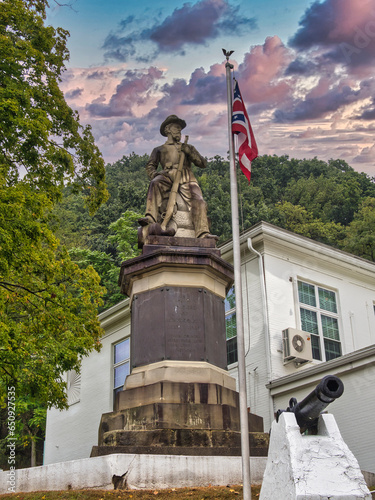 Statue of a civil war Union soldier with rifle in hand seated on a stack of logs in Pomeroy Ohio near the Meigs county Courthouse photo