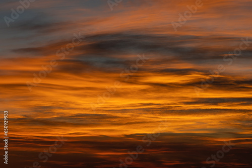 Curving Clouds Make A Faint Eye In The Colors at Sunset