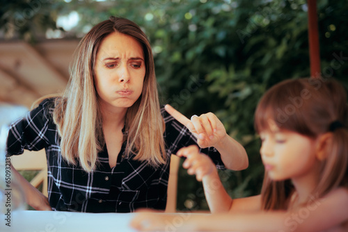 Tired Mother Saying No to her Daughter Scolding her. Funny mom and child having a moment of disagreement
 photo