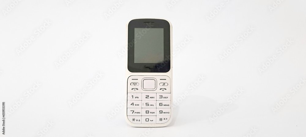 White old handphone on white background. This phone has a classic design before the smartphone era White old handphone on white background. This phone has a classic design before the smartphone era