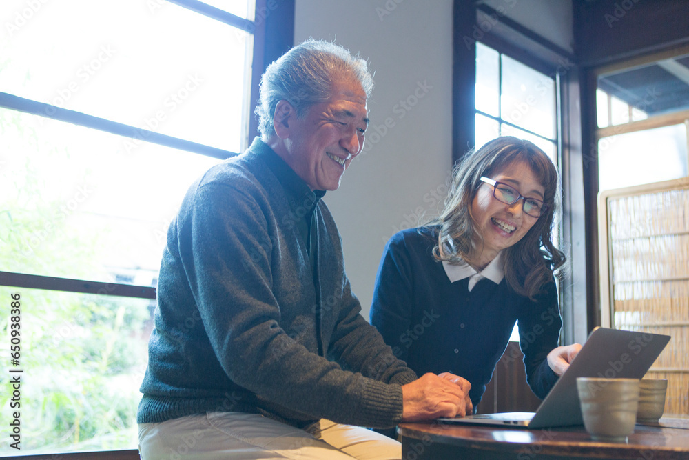 パソコンで調べ物をするシニア夫婦 パソコンで調べ物をするシニア夫婦