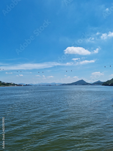 This is a seascape with a cable car.