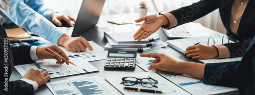 Auditor and accountant team working in office, analyze financial data and accounting record with calculator. Accounting company provide finance and taxation planning for profitable cash flow. Insight photo