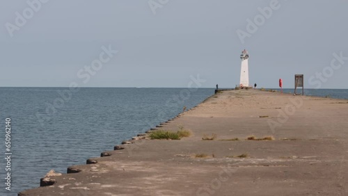 Tilt up shot of the light houses at Sodus point New York vacation spot at the tip of land on the banks of Lake Ontario. photo