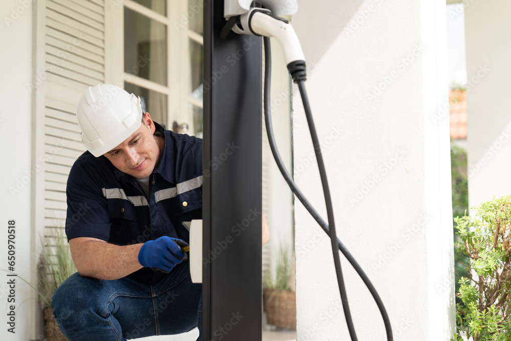 Qualified technician install home EV charging station, providing