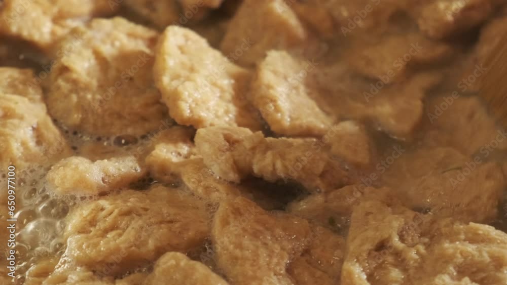 Close up view of cooking vegan TVP Textured Vegetable Protein in a pan, in slow motion 4K Close up view of cooking vegan TVP Textured Vegetable Protein in a pan, in slow motion 4K