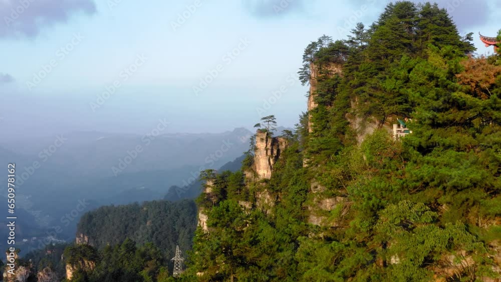 Tourists  waving at drone on stone pillars of Zhangjiajie National Park