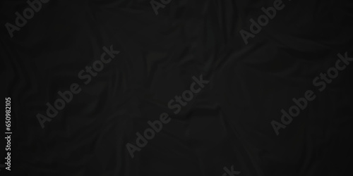 Dark crumple black paper wrinkled poster template ,blank glued creased paper texture background. black paper crumled backdrop background. used for cardboard and clarkboard.