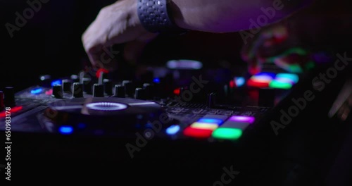 DJ Mixing in club booth and Colorful CD Turntable photo